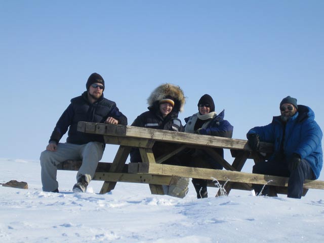 That is not a smile, it is a grimace on Greg's face. He had to use his gloves to prop up the camera...